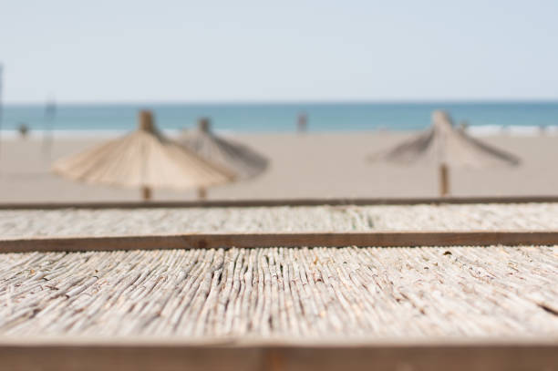straw sunshades at the sandy beach
