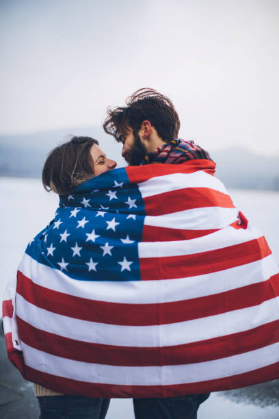 istock Couple looking each other under American flag 873684348