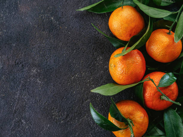 istock Tangerines, oranges, mandarins on black background 873684596