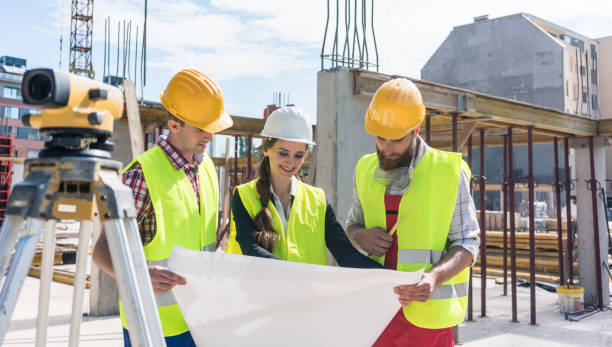 istock Experienced architect analyzing a blueprint on the construction site of a modern building 873690776