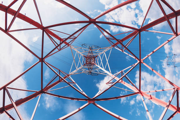 istock Low Angle View Of High Voltage Electricity Tower With Cables Against Cloudy Blue Sky 873691004