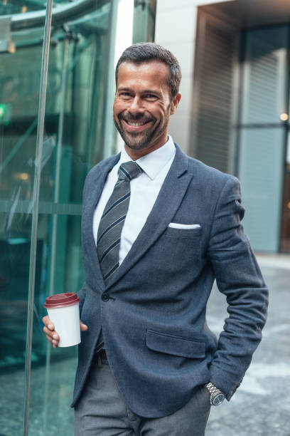 istock Businessman drinking coffee after business lunch 873694214