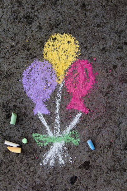 istock chalk drawing on asphalt: colorful balloons 873701542