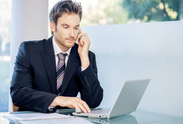 istock Young businessman reading document on the laptop 873702020