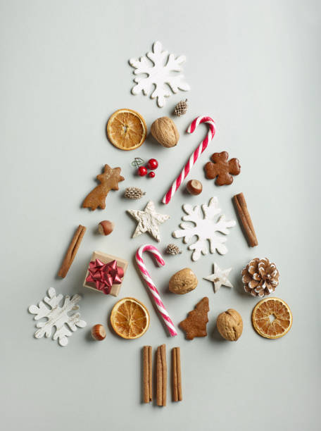 Christmas tree of various decorations Christmas tree of various decorations on grey paper background, top view walnut cookies stock pictures, royalty-free photos & images