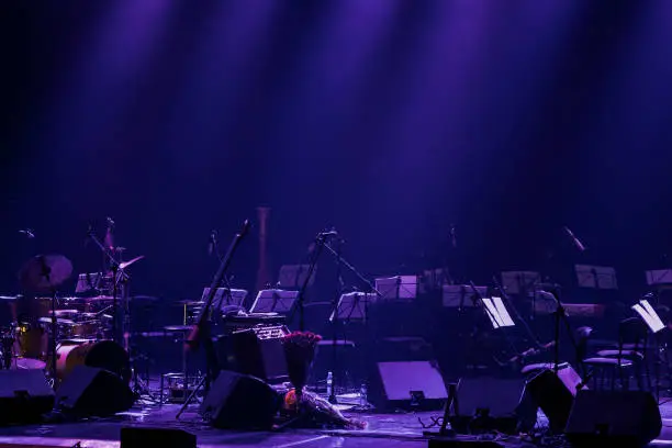 Dark purple background of the theater stage waiting for the symphonic orchestra