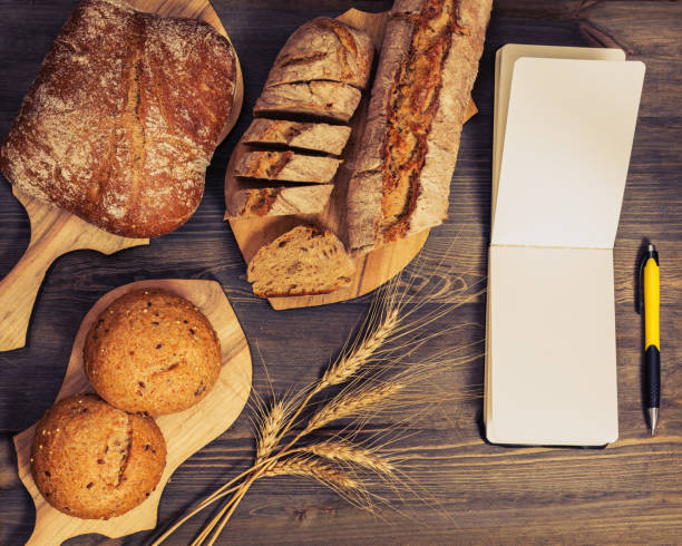 istock Composition of freshly baked bread on chopping boards 873706110