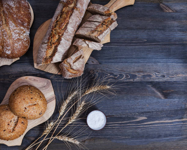 istock Composition of freshly baked bread on chopping boards 873706114