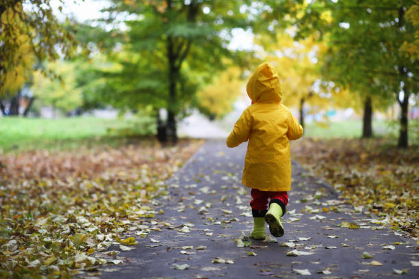 istock Children in the autumn park walk 873708570