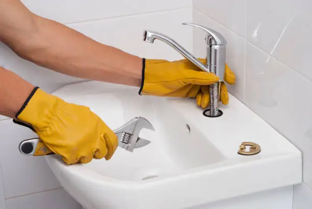 Photo of plumber installs a new faucet