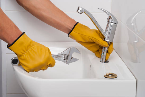 istock plumber installs a new faucet 873709174