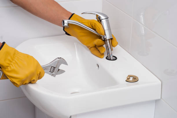 istock plumber installs a new faucet 873709190