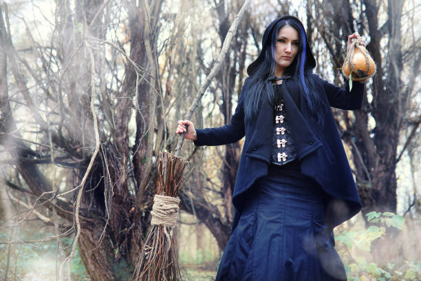 istock A woman in a witch suit in a forest 873711840