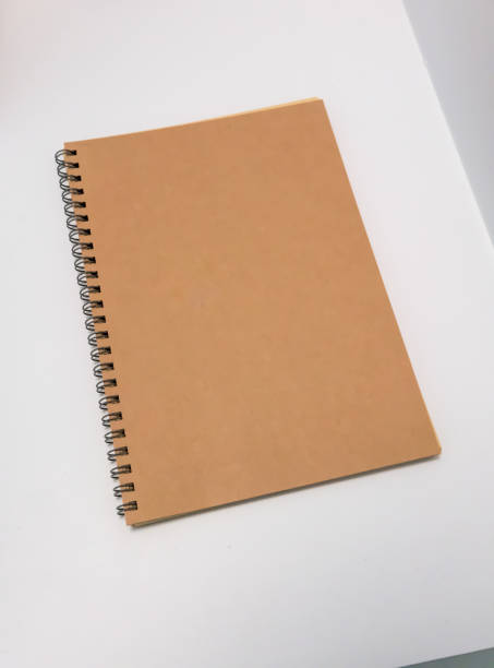 istock Blank recycled paper desk spiral calendar on white table. 873712662