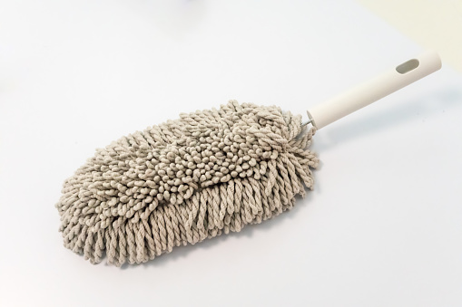 Microfiber brush duster with white handle for cleaning isolated on white background.