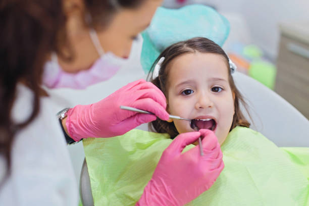 istock Cute girl teeth checkup 873715688