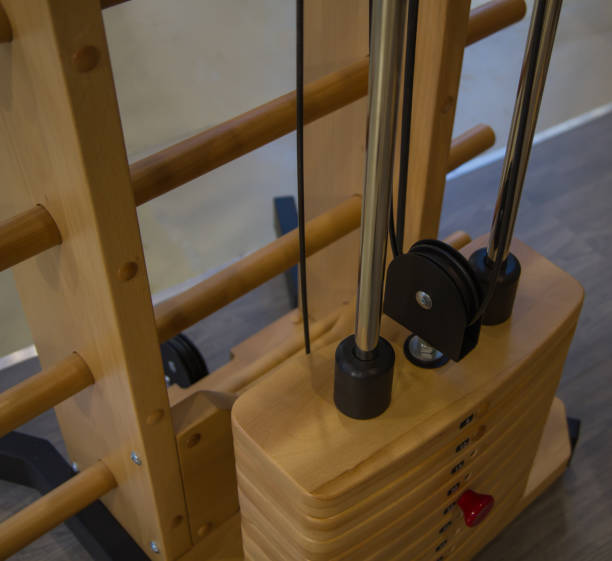 istock innovative, special wooden weight stack simulator close up in the gym, different weight, stylish design yellow 873718802