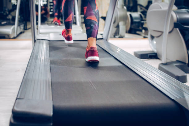 istock Close up of women while walking on machine 873719676