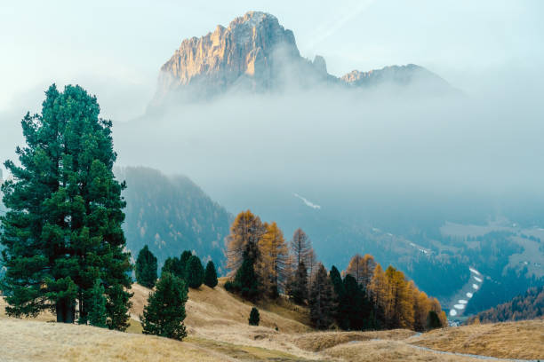 Scenic  landscape view of  Dolomites mountains in fog at sunrise, Italy