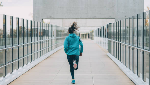 istock Woman running on a bridge 873722452