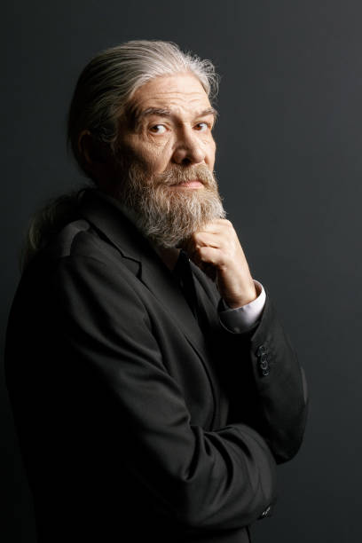 istock Old man with long grey hair and beard on black background 873722500