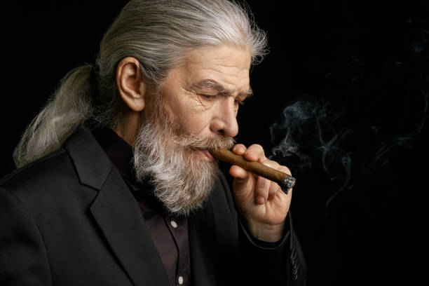 istock Side view of wrinkled stylish man with a cigar 873725494