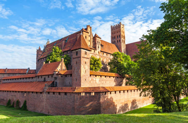 Malbork castle in Pomerania region of Poland Malbork: Malbork castle in Pomerania region of Poland. UNESCO World Heritage Site. Teutonic Knights' fortress also known as Ordensburg Marienburg. Picturesque view in sunny summer day malbork photos stock pictures, royalty-free photos & images
