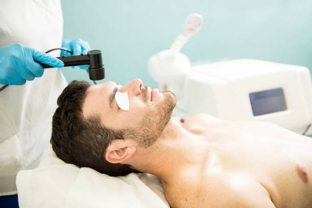 istock Man getting RF facial in a spa 873736650
