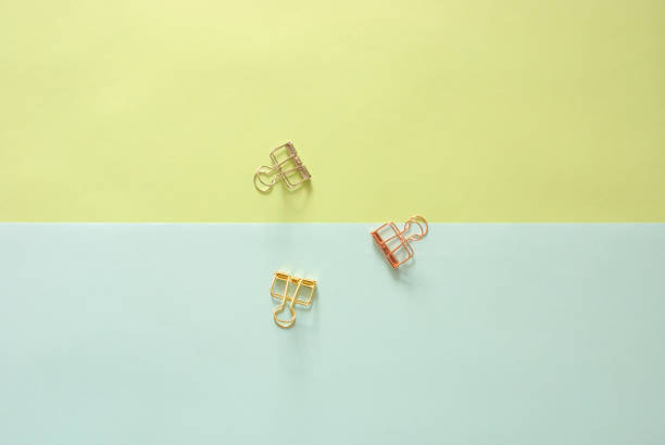 istock Minimal work space - Creative flat lay photo of workspace desk with paperclips on copy space pastel background. Top view , flat lay photography. 873745902