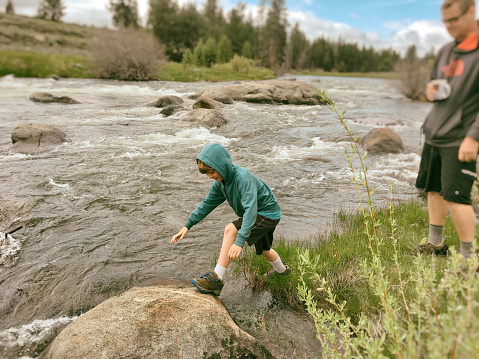 child playing with his father on the Truckee river