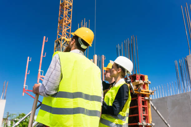 istock Experienced female architect or manager guiding the workers on the construction site 873746172