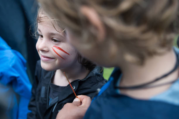 istock child being painted by a local in the amazon 873746186