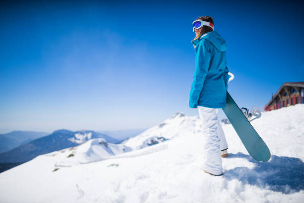 istock young  snowboarder woman 873746394