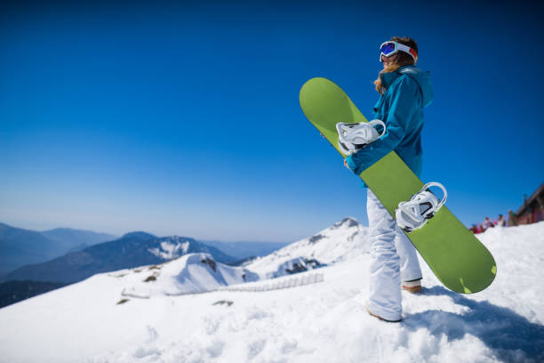 istock young  snowboarder woman 873746396