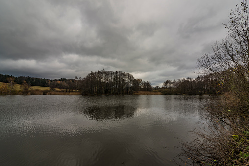 Sychrov pond near Horni Studenky village in dark autumn day