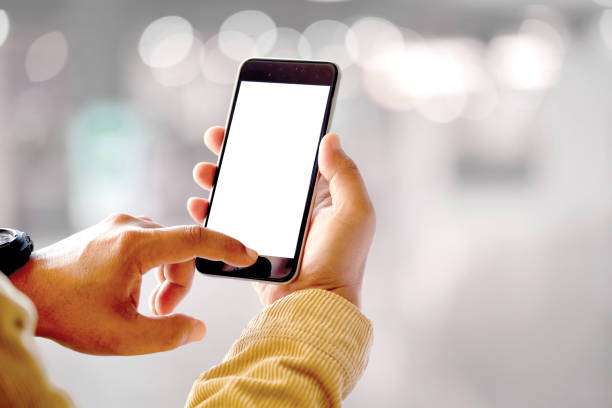 istock Mock up smartphone blank screen in man hands in blurred office interior background. 873747286