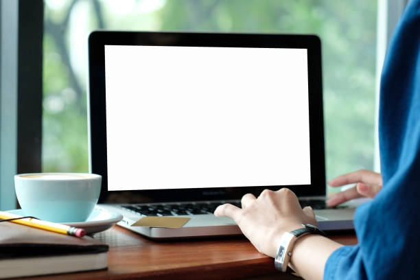 istock Woman hands typing laptop computer with blank screen for mock up while sitting by the window, technology and lifestyle concept 873751222