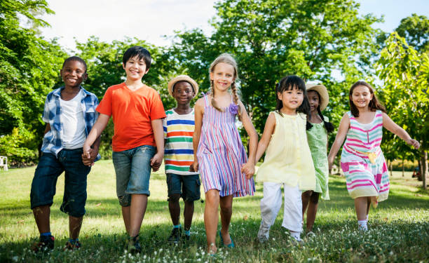 istock Group of diverse kids having fun together in the park 873753640