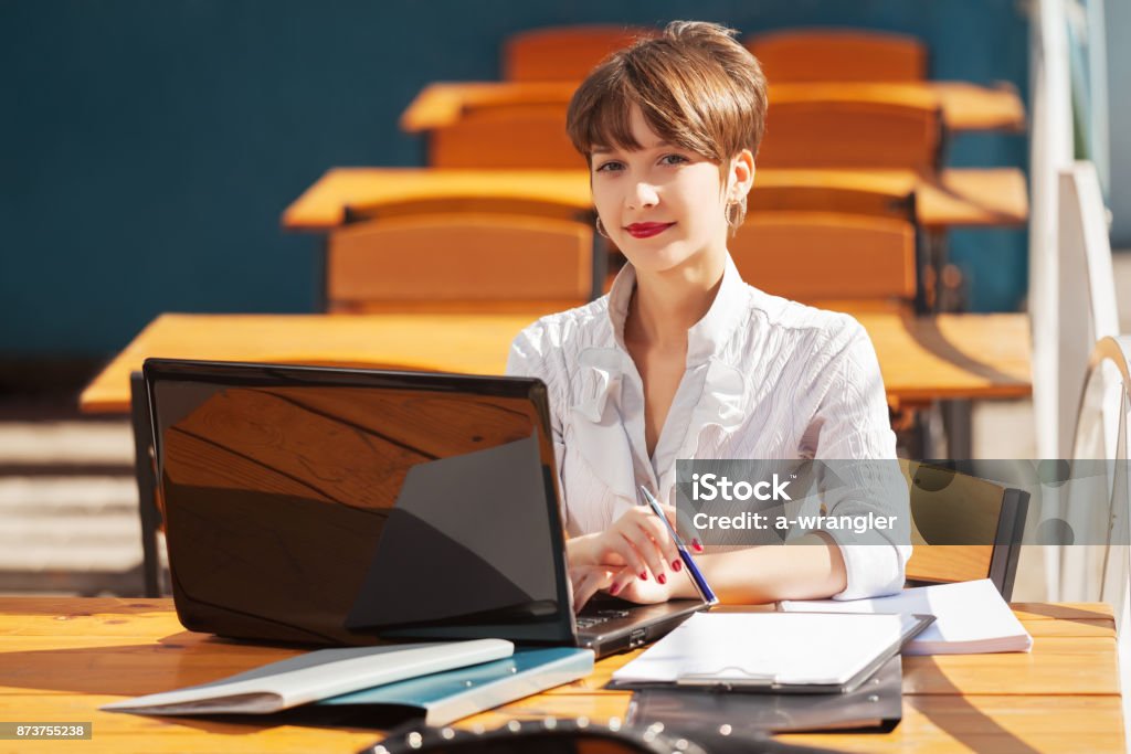Young fashion business woman using laptop at sidewalk cafe 20-29 Years Stock Photo