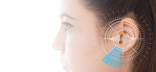 Hearing test showing ear of young woman with sound waves simulation technology stock photo