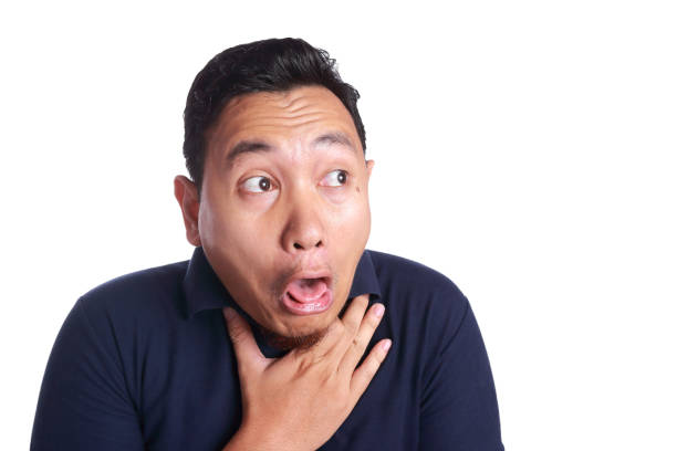 Funny Asian man chocked with tongue out isolated on white