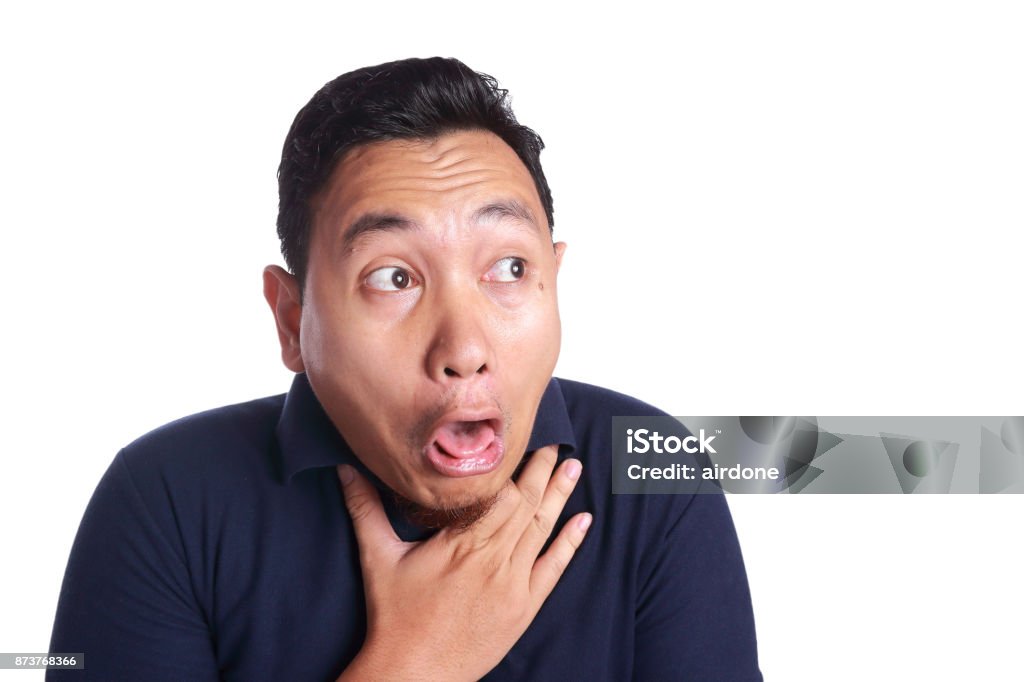 Asian Man Chocked with Tongue Out Funny Asian man chocked with tongue out isolated on white Disgust Stock Photo