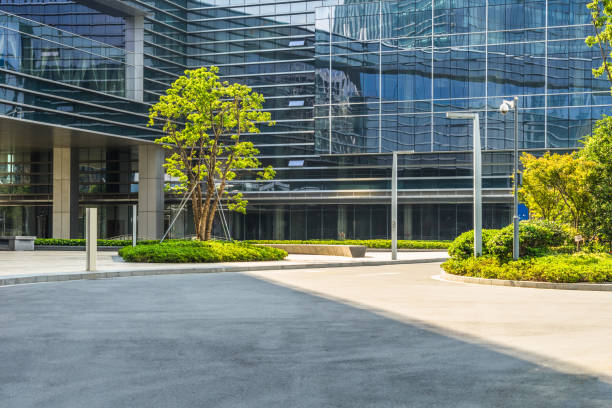 istock empty asphalt road front of modern buildings at sunny day 873769726