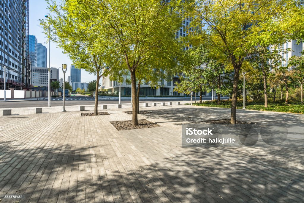 beautiful park front of the modern office building at a sunny day, china. Public Park, City, Cityscape, Flowerbed, Ornamental Garden City Stock Photo