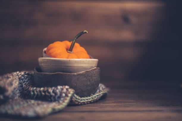 Thanksgiving still life with miniature pumpkin and bowls