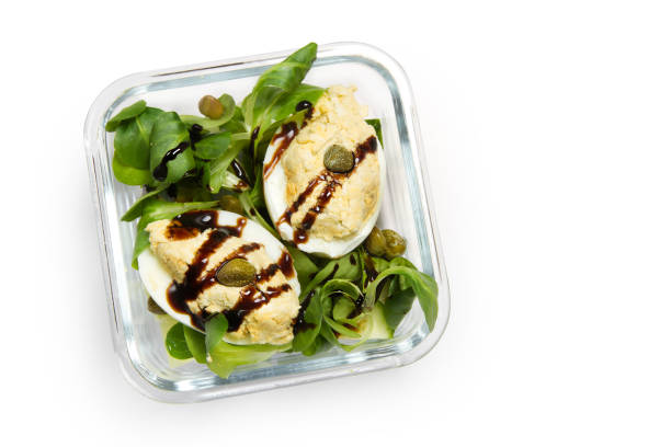 istock Lunch Box: eggs with cheese pate, cucumber, corn salad, capers and balsamic sauce 873777192