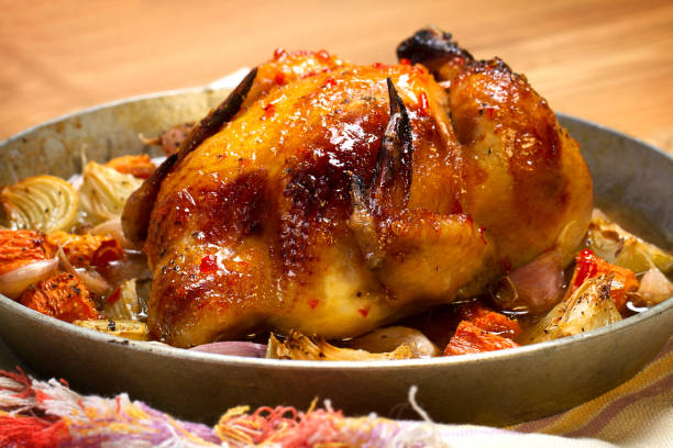 istock Whole baked chick with onion, carrots and garlic 873777332