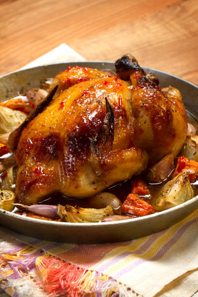 istock Whole baked chick with onion, carrots and garlic 873777398