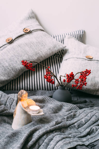 Warm knitted sweater, pillows and rowan berry. Autumn concept