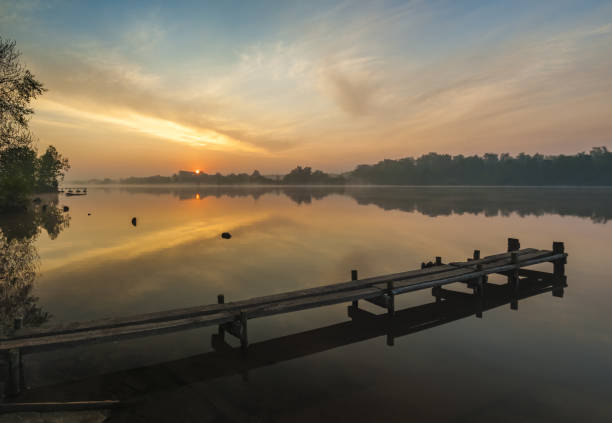 istock dawn on the lake,wooden pier 873780414